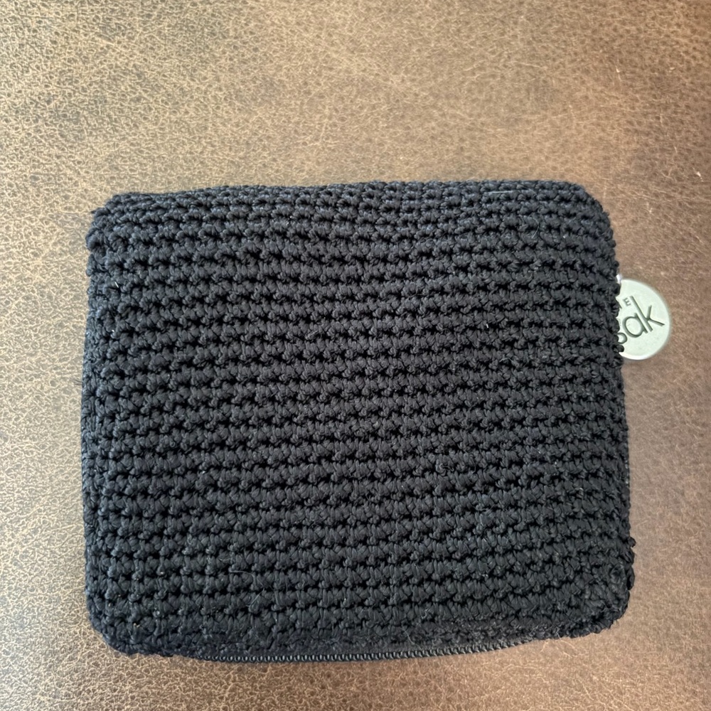 The Sak Black Crochet Zip Wallet with Silver Logo Charm